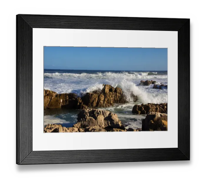 Framed Print : Foamy waves roll over rugged rocks off the point at the popular holiday resort of Buffalo Bay