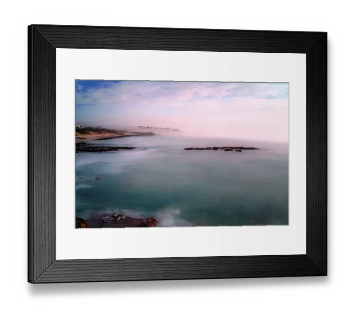 Framed Print : The fog and mist rolling in from the sea envelop the village of Arniston. A long exposure has smoothed the sea and the reflections of pink clouds on the sea are captured, Arniston, Western Cape Province, South Africa