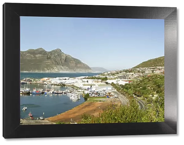 A panoramic picture of Hout Bay with Hout Bay Beach on the left and the marina and fishing harbour in the foreground. Chapmans Peak is in the background. Western Cape Province, South Africa