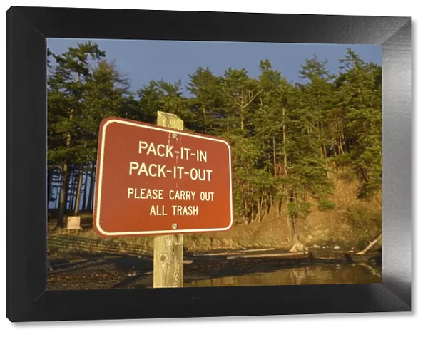 Rad sign informing to take all trash from park out, James Island, San Juan Islands, Washington State, USA