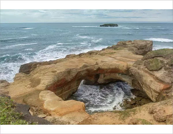 Rock arch and headland in distance, Devils Punchbowl State Natural Area, Oregon, USA