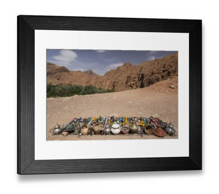 Framed Print : Vendor displays souvenirs and trinkets on blanket alongside road, Dades Gorge, Morocco