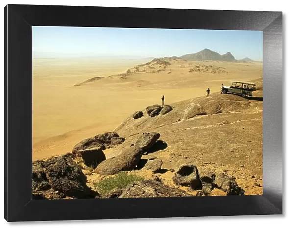 Tourists Overlooking a Vast Desert Landscape