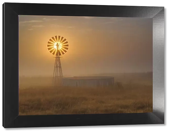 Windmill Backlit at Sunrise in the Mist and Fog of a Cold Winter Morning, Free State Province, South Africa