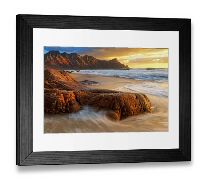 Framed Print : Dramatic Sunset over Kogel Bay in the Western Cape Province of South Africa with the Kogelberg Mountain Range forming a Stunning Backdrop Framed Print : Dramatic Sunset over Kogel Bay in the Western Cape Province of South Africa with the Kogelberg Mountain Range forming a Stunning Backdrop