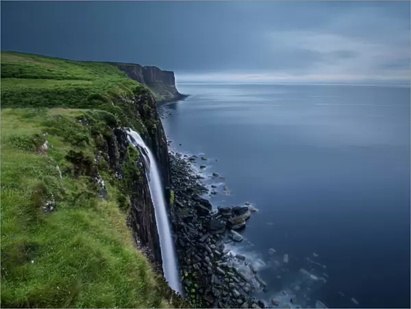 Waterfall at Kilt Rock on Isle of Skye on a gloomy cloudy morning