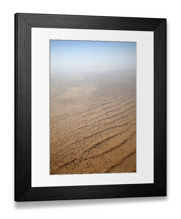 Framed Print : Flying over a settlement in the desert of the United Arab Emirates, with scattered habitation, a road and agriculture. The desert merges with the sky Framed Print : Flying over a settlement in the desert of the United Arab Emirates, with scattered habitation, a road and agriculture. The desert merges with the sky