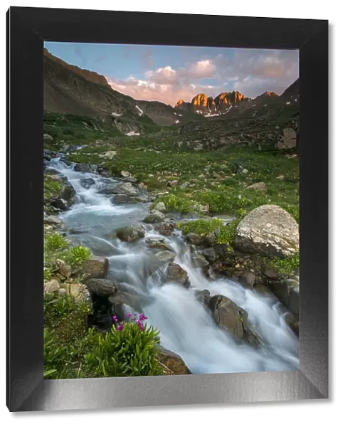 Alpine stream and Rocky Mountain in distance at sunset, American Basin, Colorado, USA