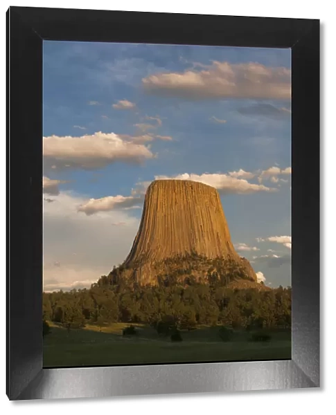 Columnar basalt formations with clouds at sunset, Devils Tower National Monument, Wyoming, USA