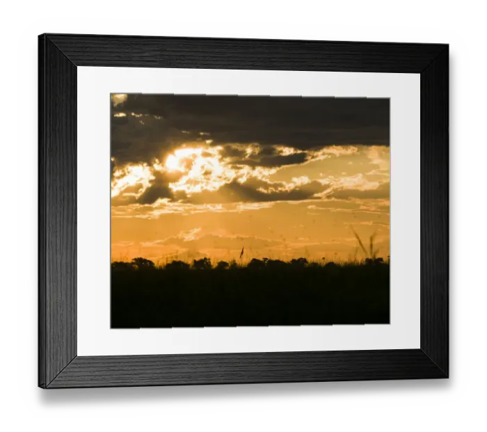 Framed Print : Sunlight breaks through the clouds over the african savannah Framed Print : Sunlight breaks through the clouds over the african savannah