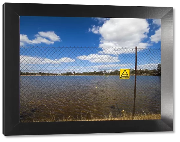 A fenced off area and poison warning sign at the Robinson Dam in Randfontein, South Africa which is highly toxic due to years of Acid Mine Drainage