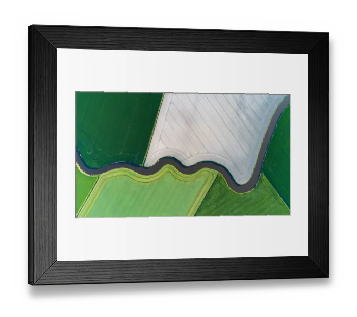 Framed Print : Cultivated land with natural stream seen from above Framed Print : Cultivated land with natural stream seen from above