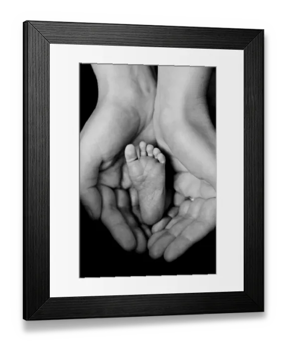 Framed Print : Mothers hands cradling babys foot