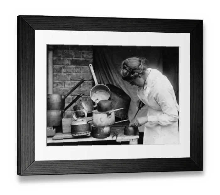 Framed Print : Tinkering. circa 1930: A woman mending pots and pans Framed Print : Tinkering. circa 1930: A woman mending pots and pans