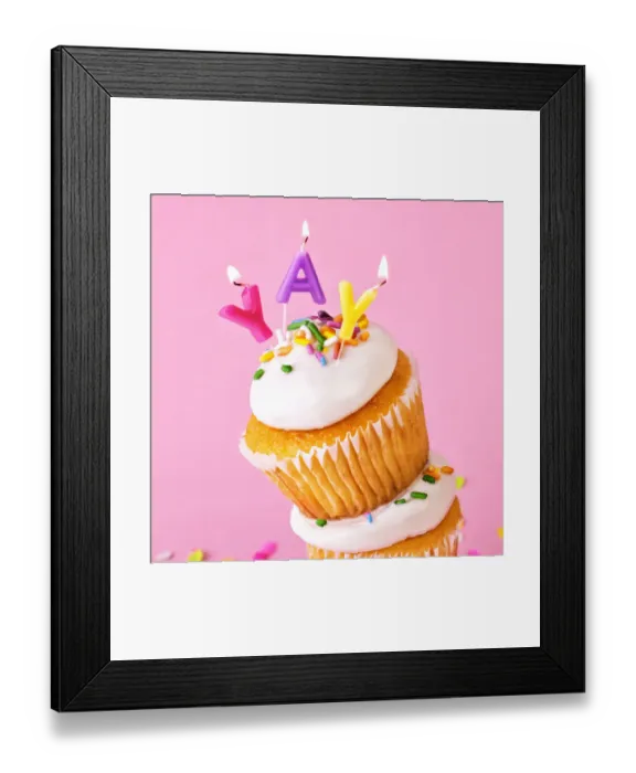 Framed Print : Frosted cupcakes with sprinkles and candles on pink background with confetti