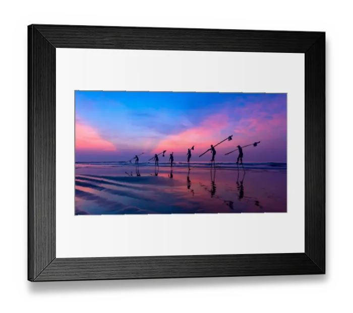 Framed Print : Vietnam - Fishermen going with stilts, hanging fishing tools on the beach, in sunrise Framed Print : Vietnam - Fishermen going with stilts, hanging fishing tools on the beach, in sunrise