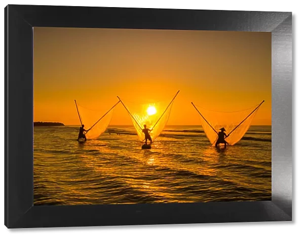 Three fisherman with golden fishing net, sun, dawn, Vietnam