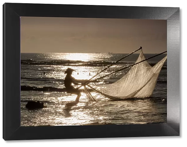 One fisherman on the beach, dawn, Vietnam
