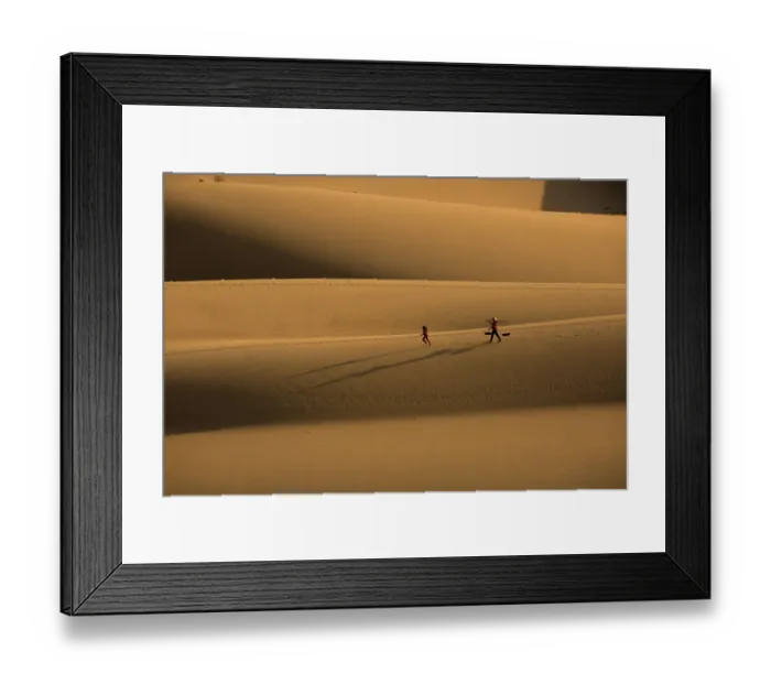 Framed Print : Woman walking, girl running on sanddune Framed Print : Woman walking, girl running on sanddune