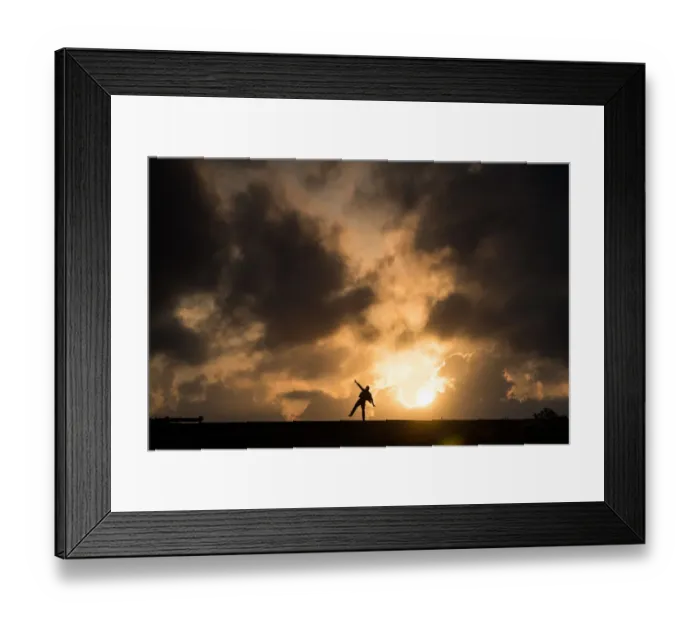 Framed Print : One man standing in causeway over cloudy sunset Framed Print : One man standing in causeway over cloudy sunset