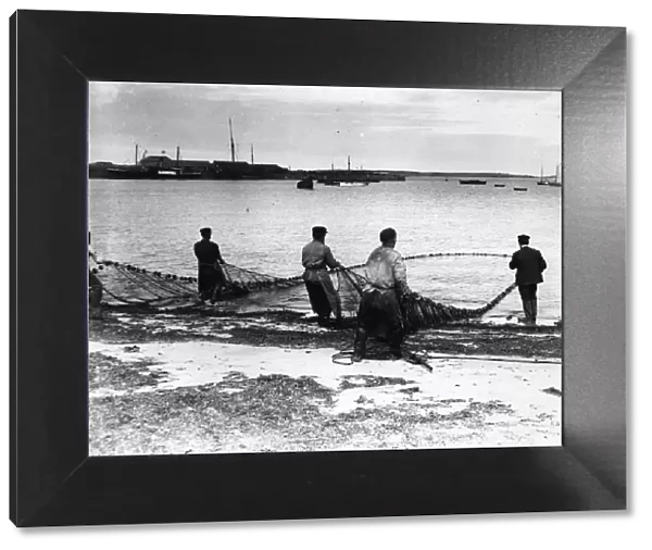 Full Nets. circa 1900: Fishermen bringing in the catch in the Scilly Isles