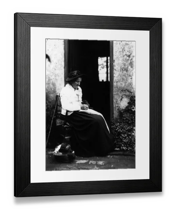 Framed Print : Darning. circa 1900: An old woman sits outside darning socks Framed Print : Darning. circa 1900: An old woman sits outside darning socks