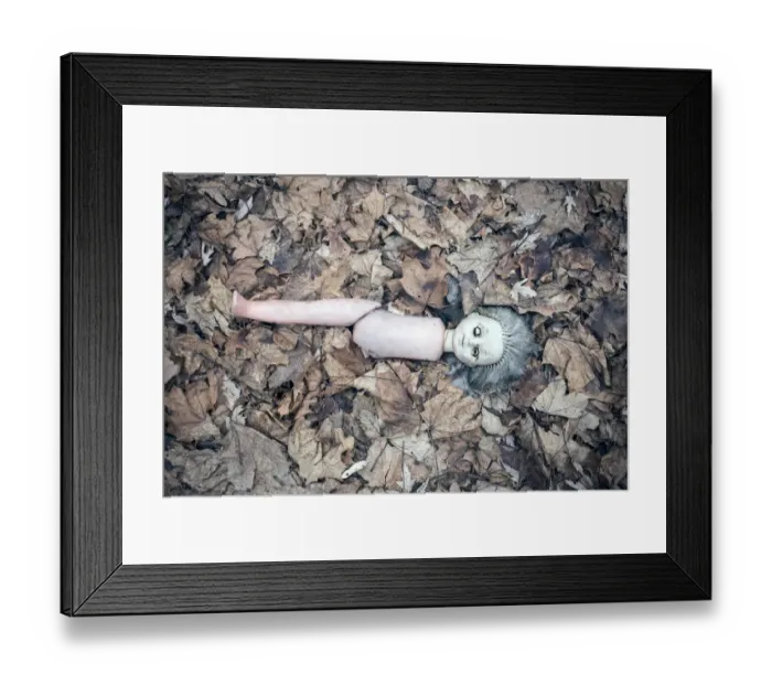 Framed Print : Broken doll lying in the front garden of an abandoned kindergarten, village in