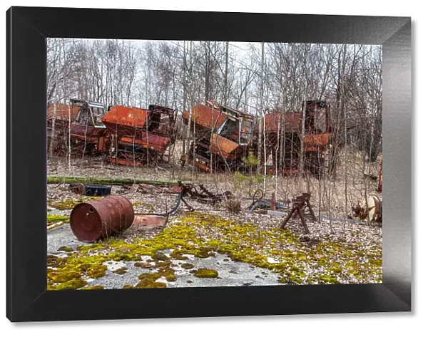 Rusty harvesters in an abandoned farm. Chernobyl zone, Ukraine