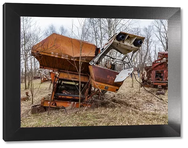 Rusty harvesters in an abandoned farm. Chernobyl zone, Ukraine