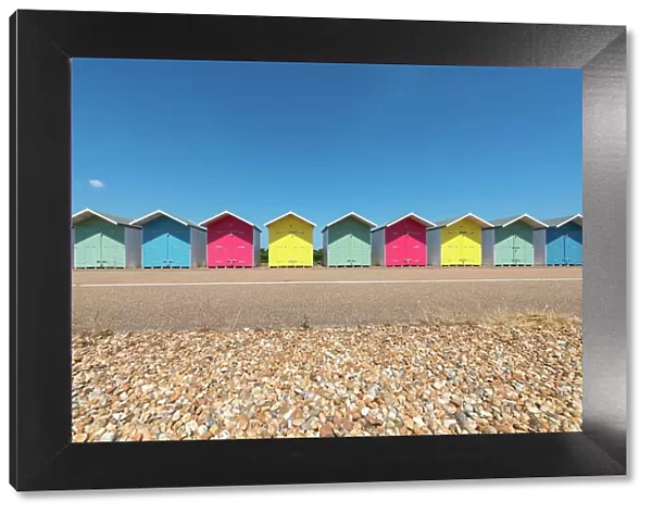 A Row of Multi-Coloured Beach Huts along the Promenade, Eastbourne, East Sussex