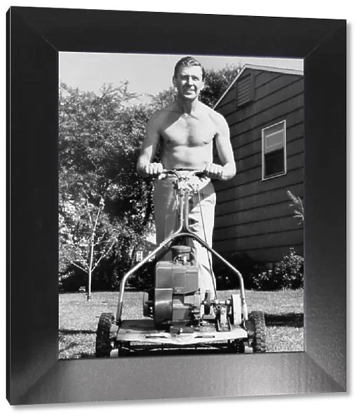MAN MOWING HIS LAWN, 1950S