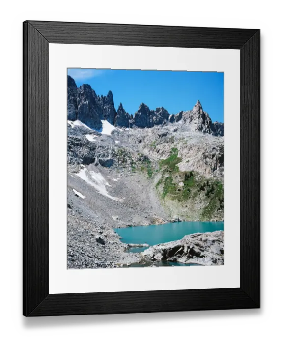 Framed Print : Man on shore of alpine lake with mountain peaks Framed Print : Man on shore of alpine lake with mountain peaks