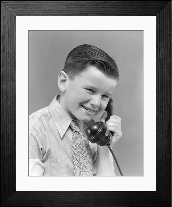 Framed Print : Boy talking on telephone, smiling Framed Print : Boy talking on telephone, smiling