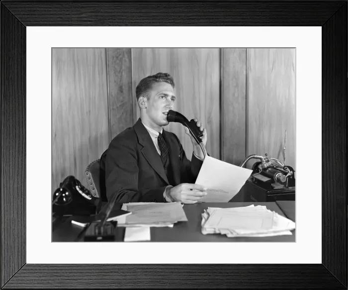 Framed Print : Man at desk talking into Dictaphone Framed Print : Man at desk talking into Dictaphone