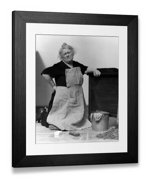 Framed Print : Woman on knees with mop and bucket, scowling Framed Print : Woman on knees with mop and bucket, scowling