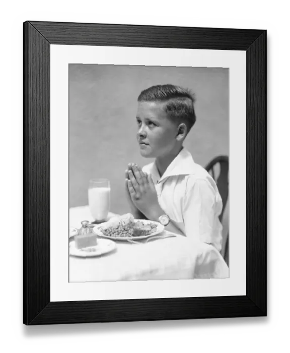Framed Print : Boy at dinner table, saying Grace Framed Print : Boy at dinner table, saying Grace