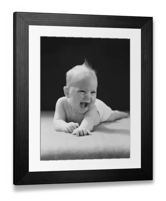 Framed Print : Five month old baby lying on stomach, arms outstretched, laughing Framed Print : Five month old baby lying on stomach, arms outstretched, laughing