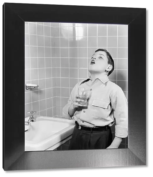 Boy gargling in bathroom