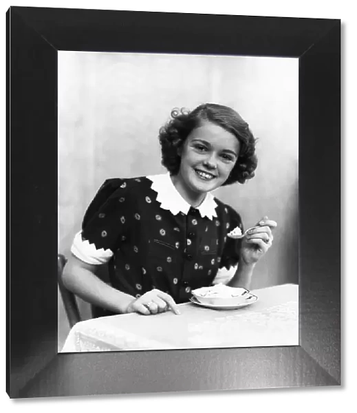 Teenage girl eating ice-cream, portrait