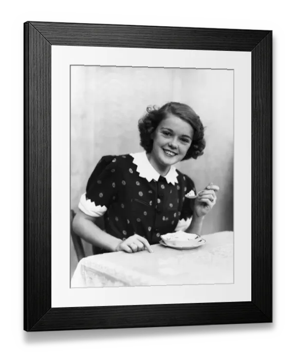 Framed Print : Teenage girl eating ice-cream, portrait Framed Print : Teenage girl eating ice-cream, portrait
