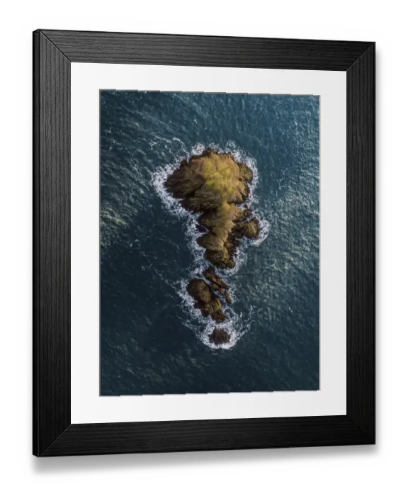Framed Print : Drone view of a rock at sea, Fishguard, United Kingdom Framed Print : Drone view of a rock at sea, Fishguard, United Kingdom