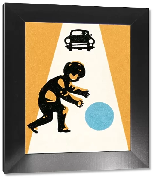 Boy with ball in street; car approaching