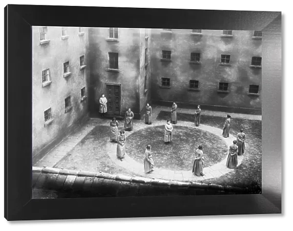 No Fun. circa 1930: A group of nuns walk round in a circle in an enclosed