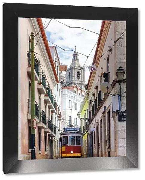 Tram in a narrow street in the old town, Lisbon, Portugal