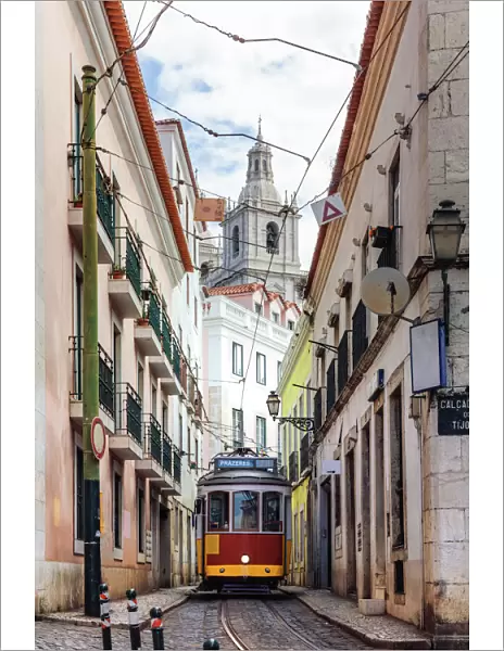 Tram in a narrow street in the old town, Lisbon, Portugal