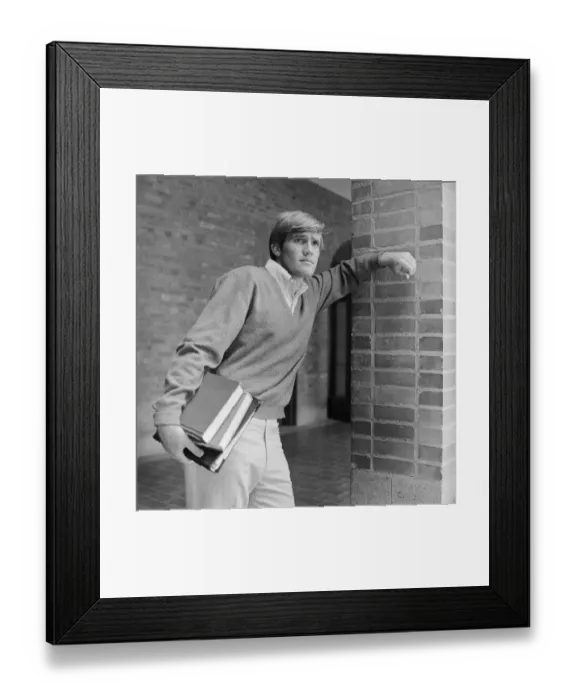 Framed Print : Young man holding books in hand Framed Print : Young man holding books in hand