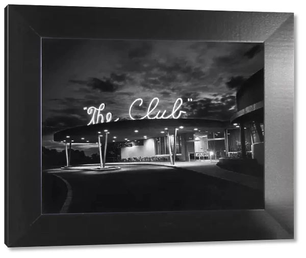 The Club. Exterior view of The Club, a private nightclub with a neon sign on its roof