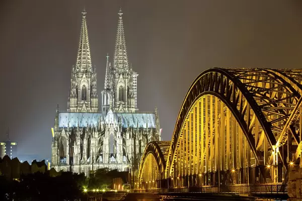 The illuminated Cologne Cathedral and Hohenzollern Bridge at night, Deutz, Cologne