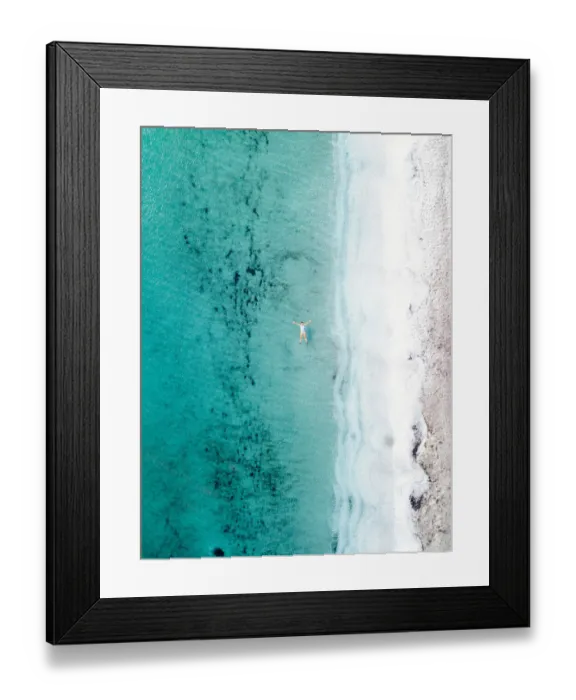Framed Print : Woman takes a bath and floats in a turquoise sea. Stintino, Sardinia, Italy. Aerial view Framed Print : Woman takes a bath and floats in a turquoise sea. Stintino, Sardinia, Italy. Aerial view