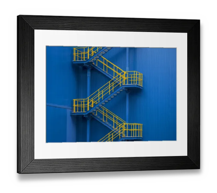 Framed Print : Yellow metal staircase against a blue wal Framed Print : Yellow metal staircase against a blue wal